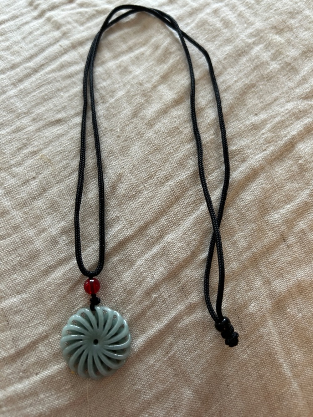 Black Cord Necklace with Light Green Carved Pendant and Red Accent